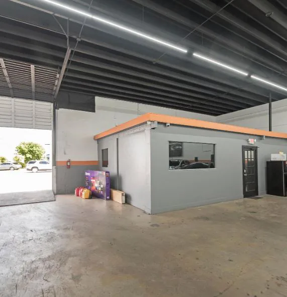 Bay B — built-out office at the overhead door